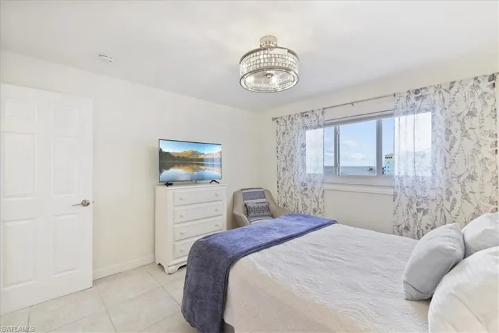 Bedroom featuring baseboards and light tile patterned flooring