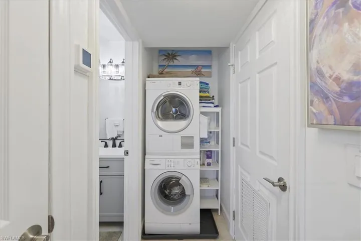 Laundry area with stacked washing machine and dryer