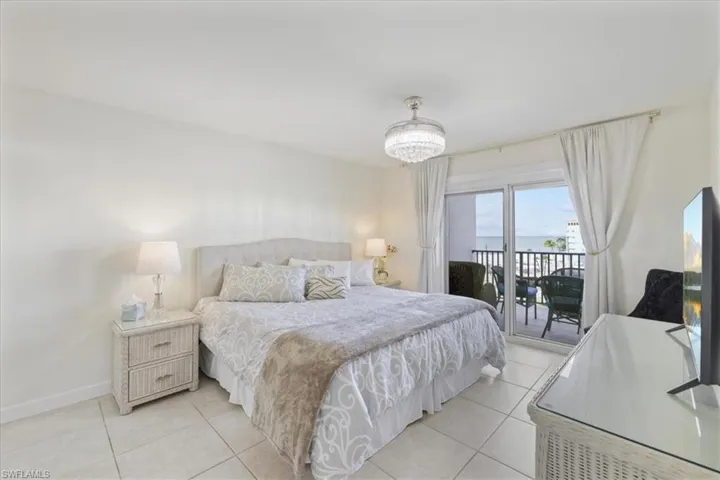 Bedroom with access to outside and light tile patterned floors