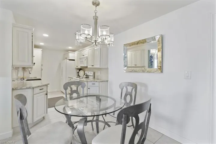 Dining area featuring suspended lighting and light tile patterned floors