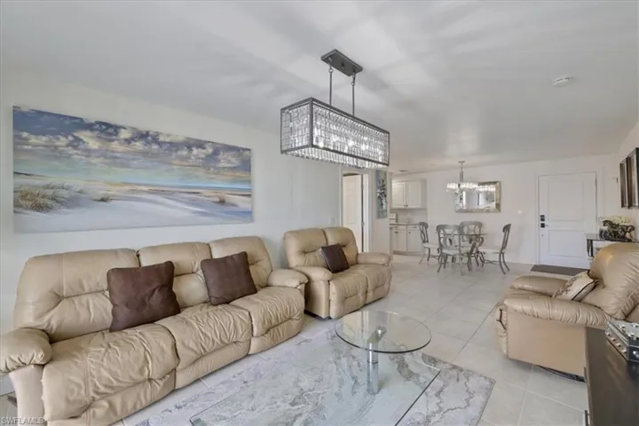 Living area featuring hanging lights and light tile patterned floors