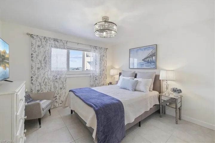 Bedroom featuring light tile patterned flooring and baseboards