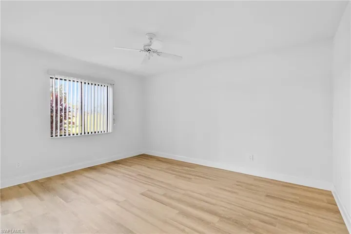 Empty room with light wood-type flooring and a ceiling fan