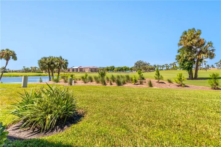 View of green lawn featuring a water view