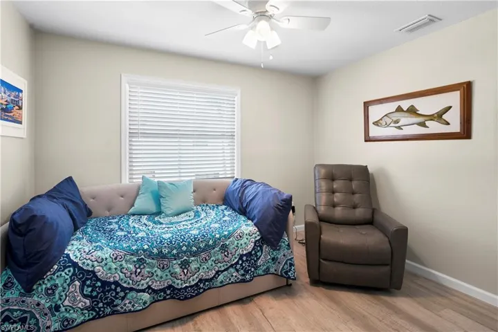 Bedroom with wood finished floors, baseboards, and ceiling fan