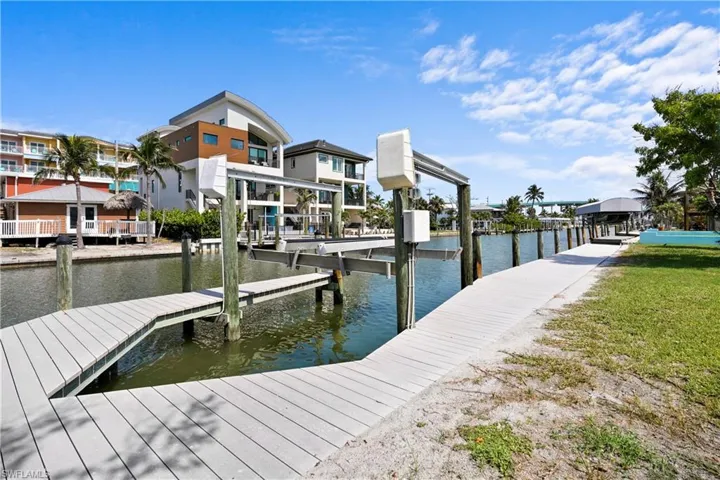 One of the the Best boating access on properties on FT Myers Beach! The first canal past the high bridge onto Ft Myers Beach from Ft Myers. Captain's walk with composite decked dock featuring boat lift and a water view. Well maintained concrete seawall. Check out the highbridge in the background. You'll be that close!