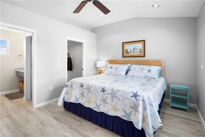 Spacious main bedroom suite features a walk-in closet and private bathroom with granite countertop, large shower and linen closet. Pocket doors help make it flow well. Light wood-style luxury vinyl floors, vaulted ceiling.