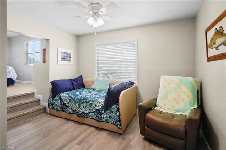 Bedroom with wood finished floors, ceiling fan, and baseboards