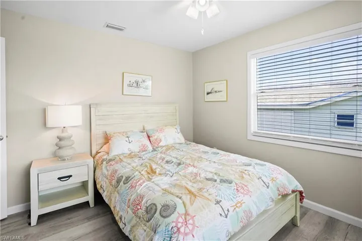 Bedroom with wood finished floors and baseboards