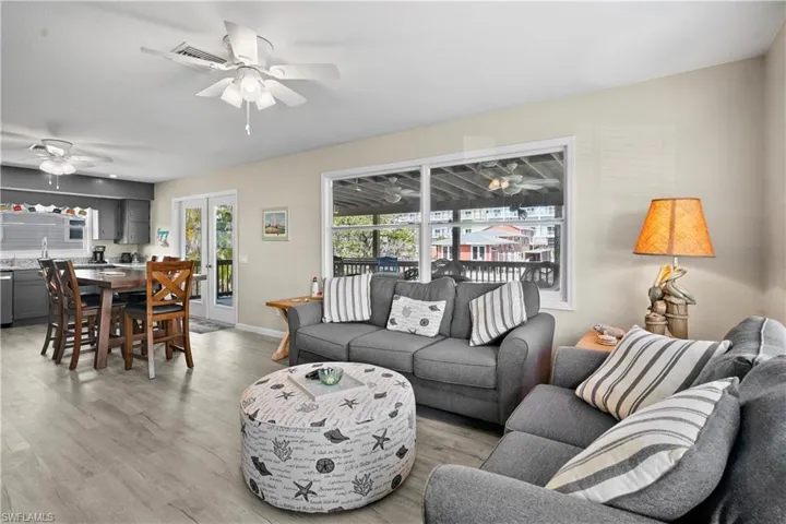 Open floor plan is great for entertaining at the beach! French doors open to a large covered deck overlooking the canel. Light wood finished luxury vinyl floors keep the beachy feel while being very easy to care for.