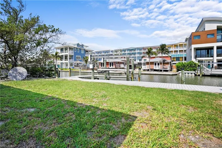 Dock area with a lawn, a water view, and boat lift
