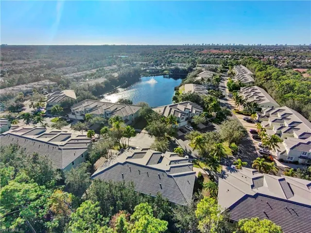 Aerial perspective of suburban area with a nearby body of water