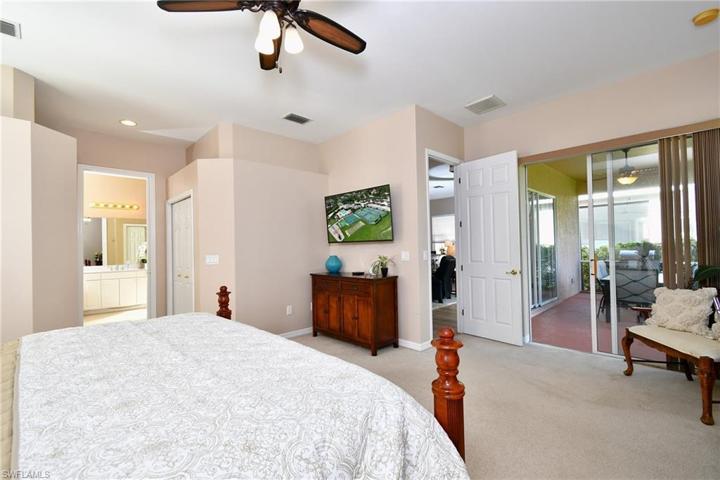 2 sliders to lanai and walk in closets flank the hallway to the master bathroom