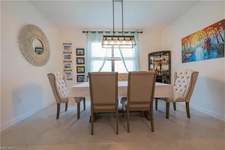 Dining space with light tile patterned floors