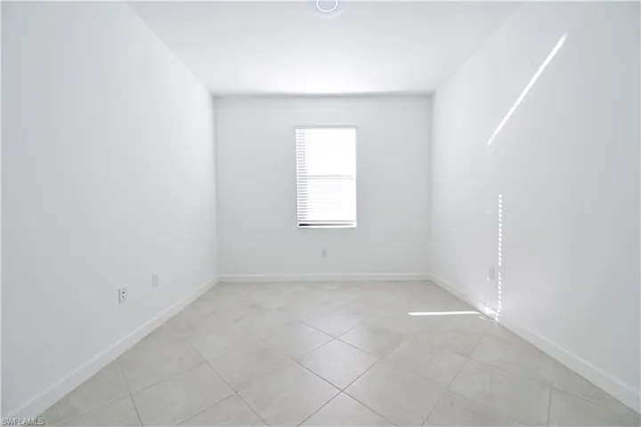 Unfurnished room featuring baseboards and light tile patterned floors