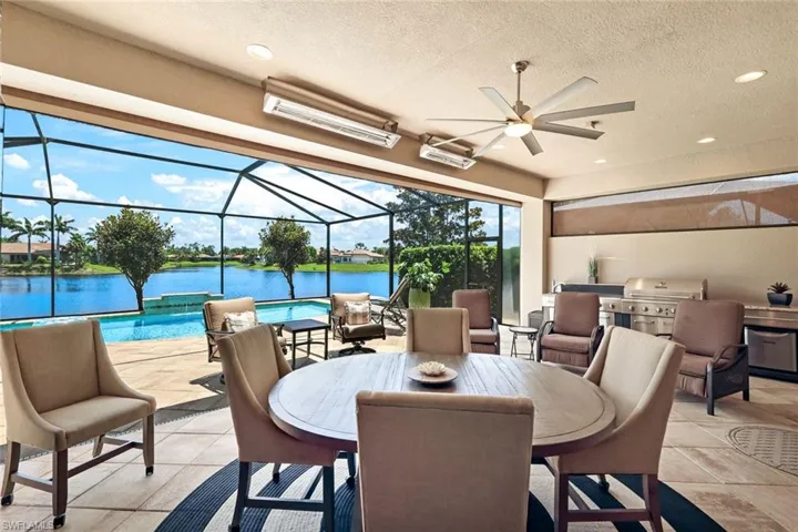 Sunroom with a water view and ceiling fan