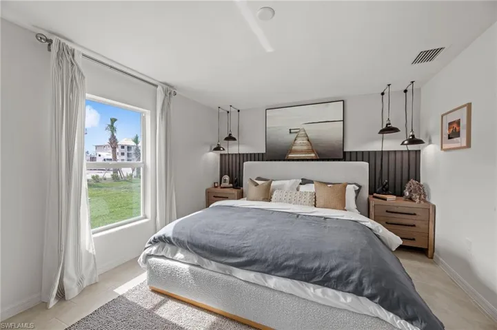 Bedroom featuring baseboards and light tile patterned flooring