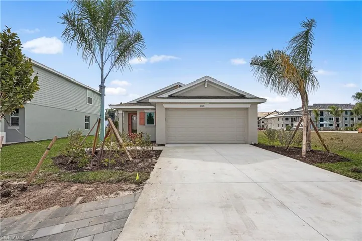 Single story home with driveway, a garage, and stucco siding