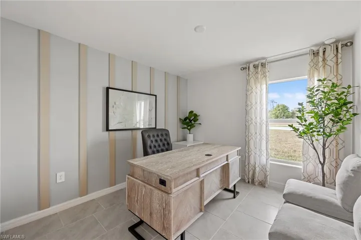 Home office featuring baseboards and light tile patterned floors