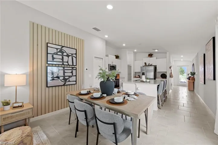 Dining space with recessed lighting and light tile patterned floors