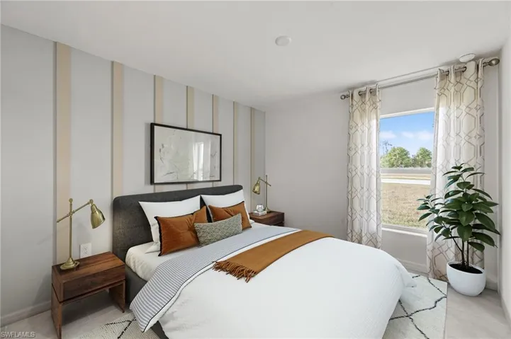 Bedroom with tile patterned flooring and baseboards