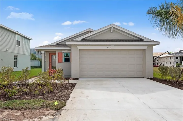 Ranch-style house featuring concrete driveway, stucco siding, and a garage