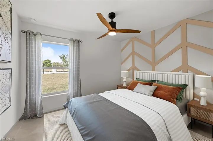 Bedroom with ceiling fan and tile patterned flooring