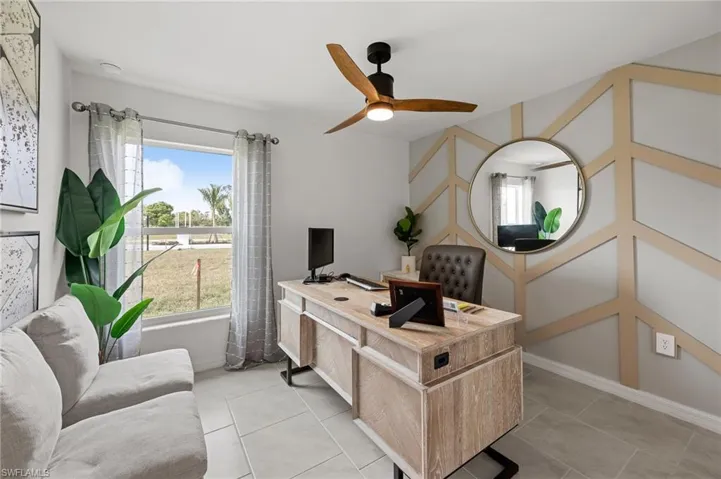 Home office featuring light tile patterned flooring and ceiling fan