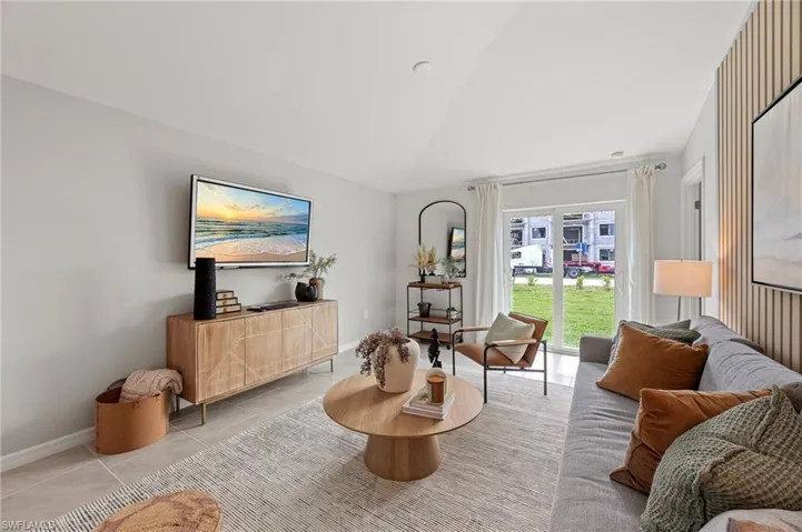 Living room featuring light tile patterned floors and baseboards