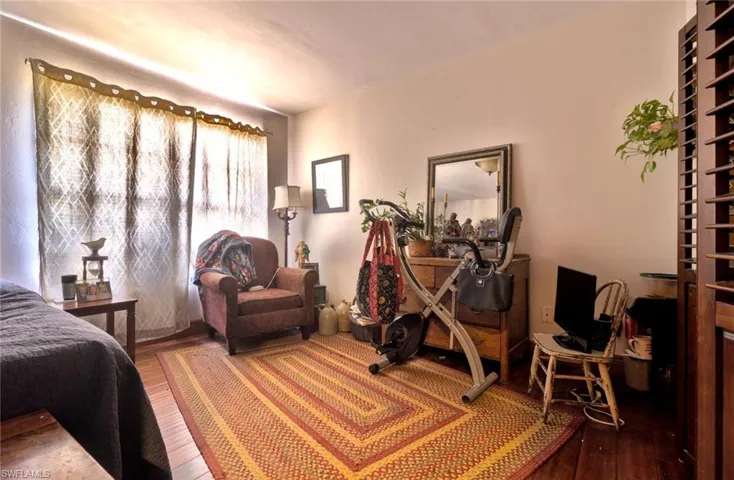 Guest bedroom featuring wood flooring and abundant natural light