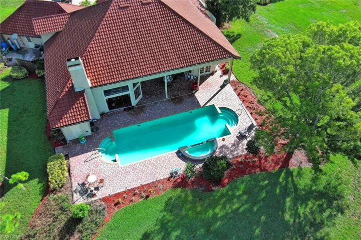 View of pool featuring a patio and a lawn