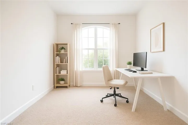 Office space with light colored carpet and baseboards