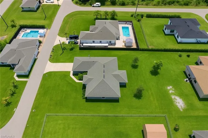 Aerial perspective of suburban area with a pool area