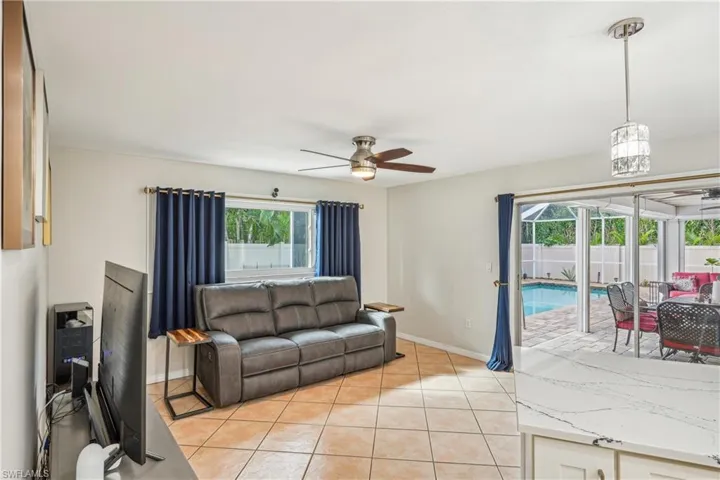 Living room featuring ceiling fan and light tile patterned floors