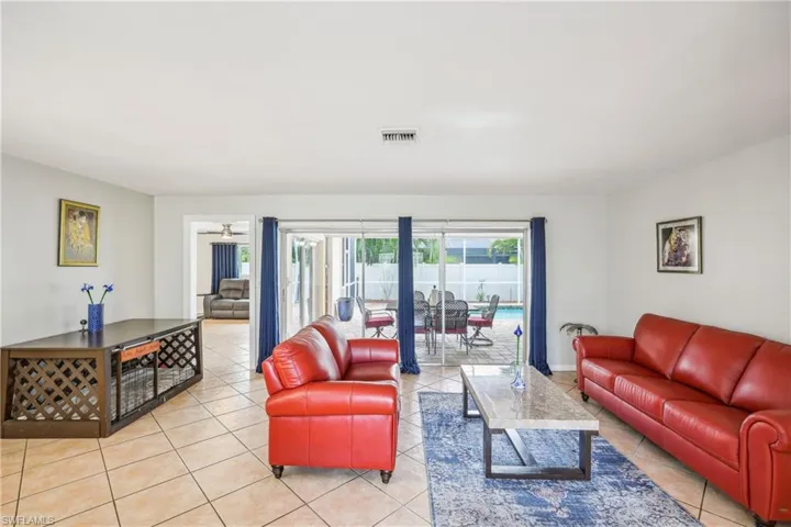 Tiled living room featuring ceiling fan