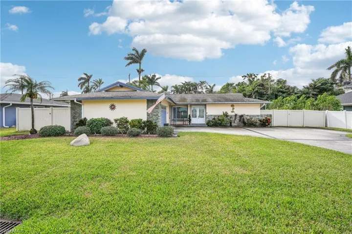 Ranch-style house featuring a front lawn