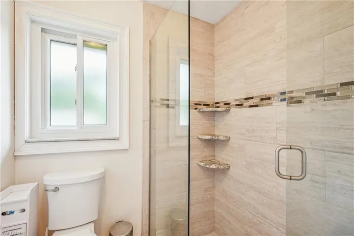 Bathroom with a wealth of natural light and an enclosed shower