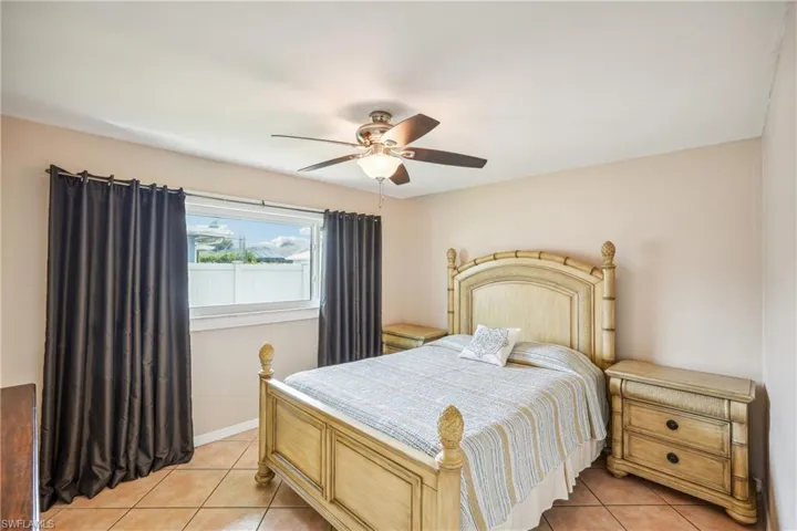 Bedroom featuring ceiling fan and light tile patterned flooring