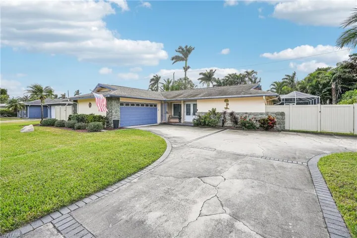 Single story home featuring a garage and a front yard