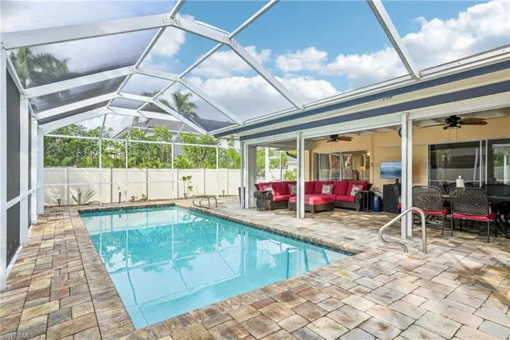 View of pool featuring a lanai, ceiling fan, a patio, and an outdoor hangout area