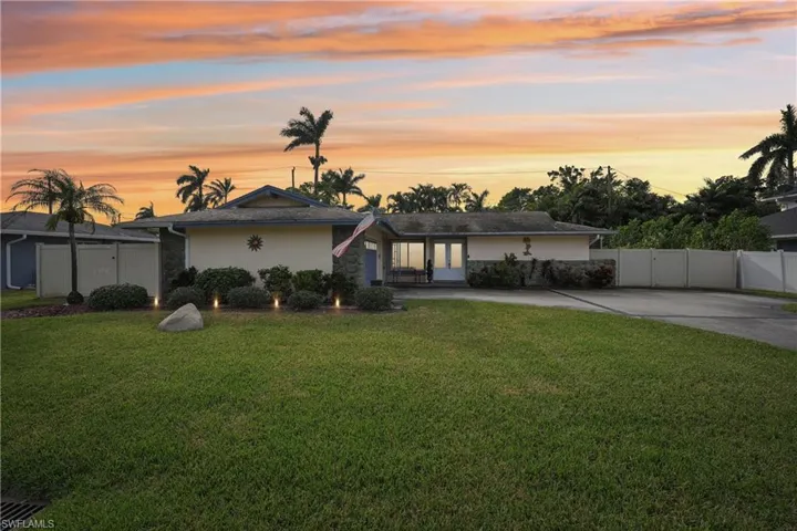 Ranch-style home featuring a lawn