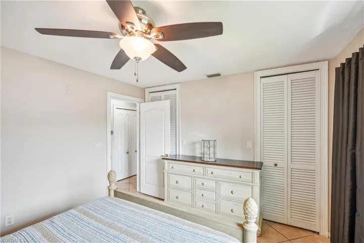 Unfurnished bedroom featuring ceiling fan and light tile patterned floors