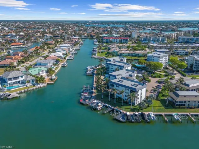 Birds eye view of property with a water view