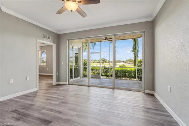 Featuring a healthy amount of sunlight, crown molding, LVP flooring, and ceiling fan