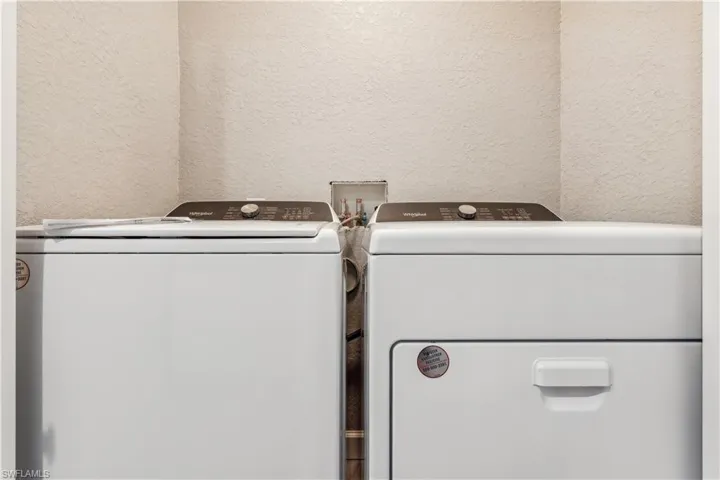 Clothes washing area featuring separate washer and dryer