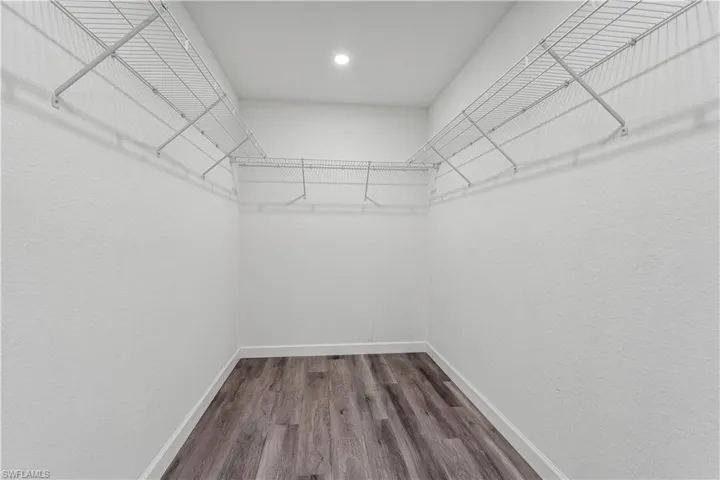 Walk in closet featuring LVP flooring