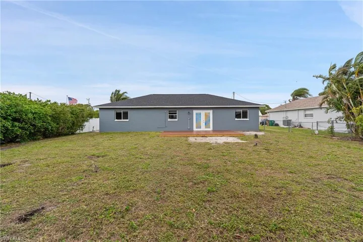 View of front facade featuring concrete driveway, an attached garage, and a front lawn