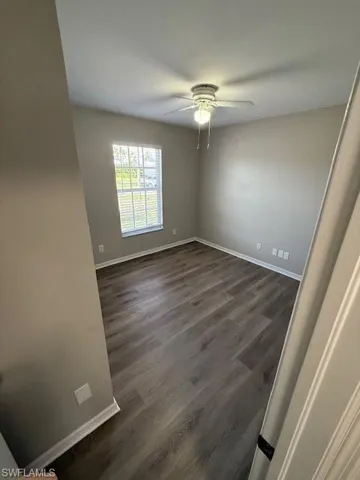 Bathroom featuring stone finish flooring, shower / tub combination, toilet, and vanity