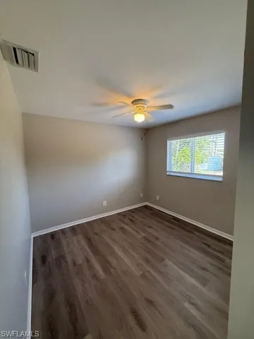 Bedroom with ceiling fan and new LV flooring.