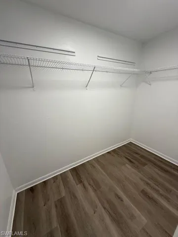Bedroom with new lv flooring, and fan.